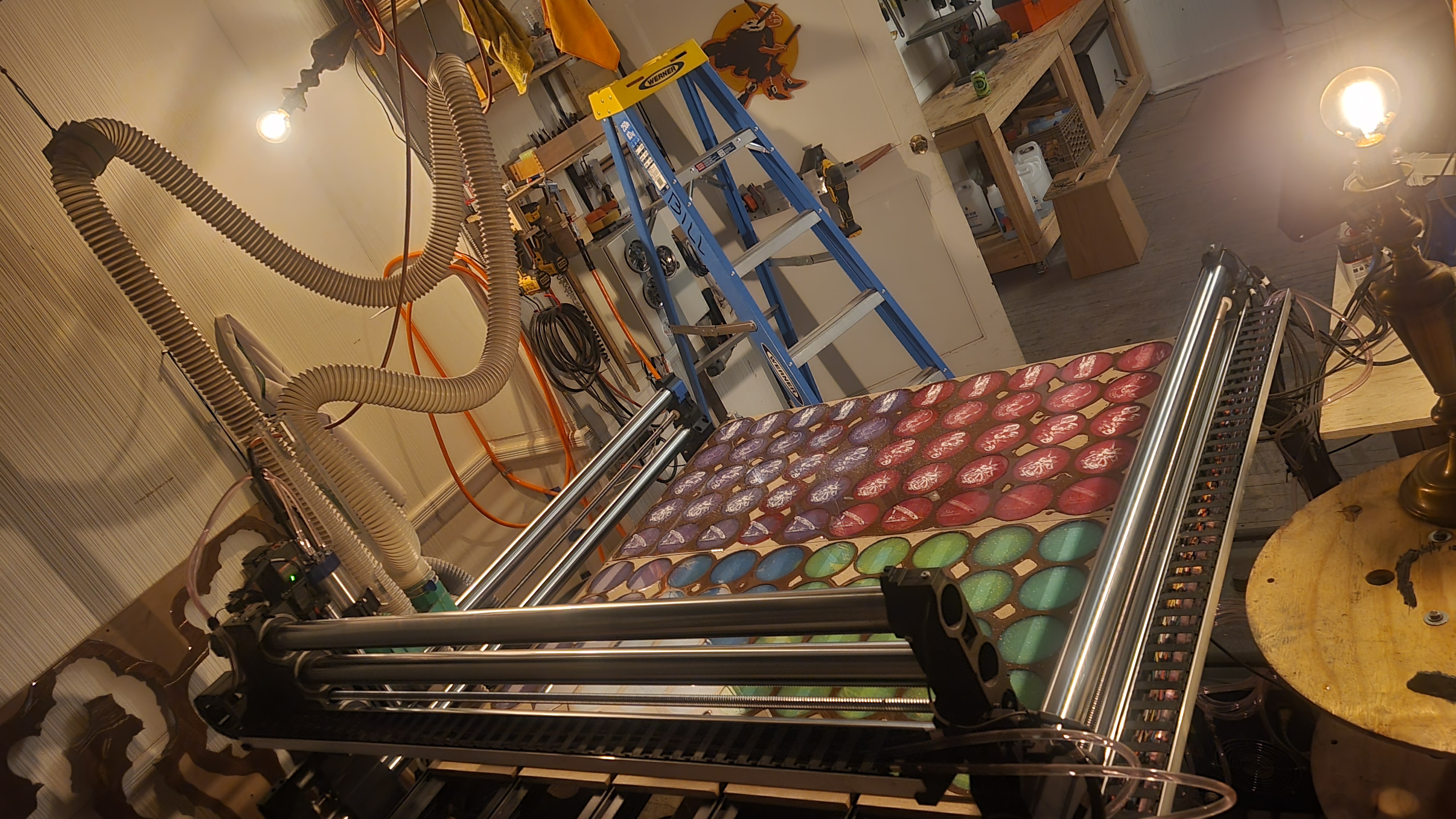 CNC router machine in romantic lighting with blue ladder